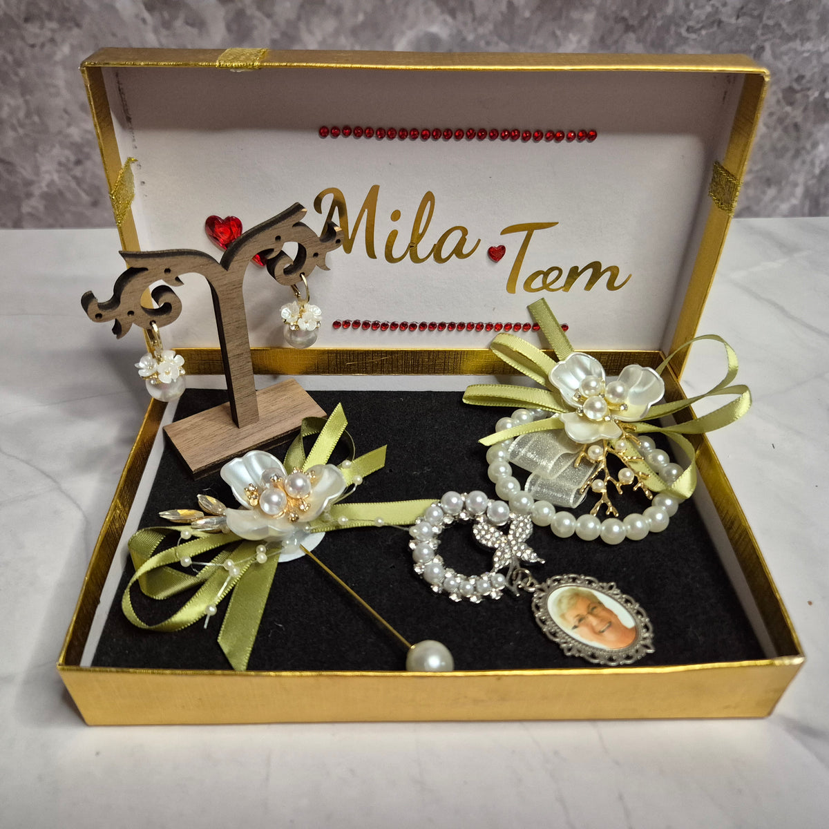 Wedding gift box with a pearl earring, pin charm, and a match corsages