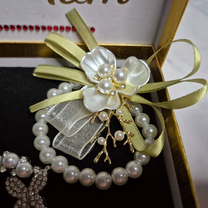 Wedding gift box with a pearl earring, pin charm, and a match corsages