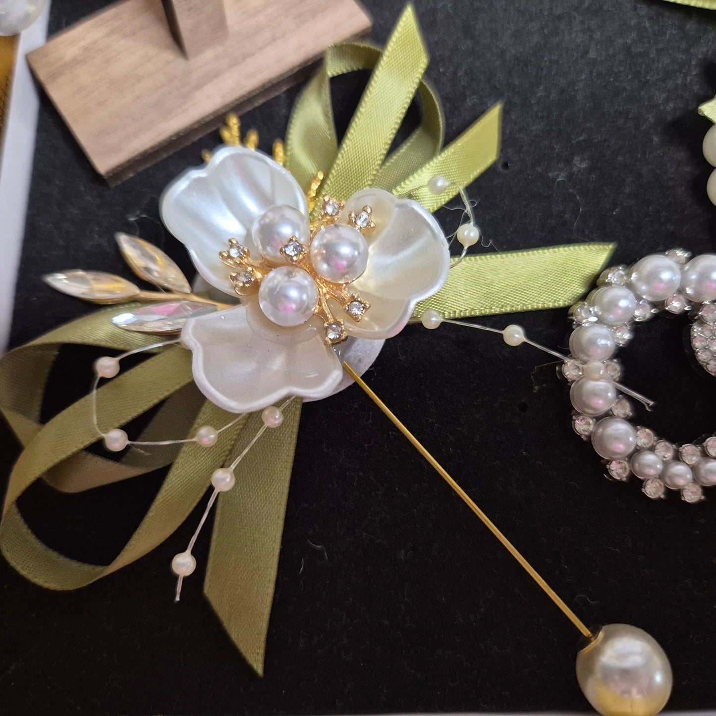 Wedding gift box with a pearl earring, pin charm, and a match corsages