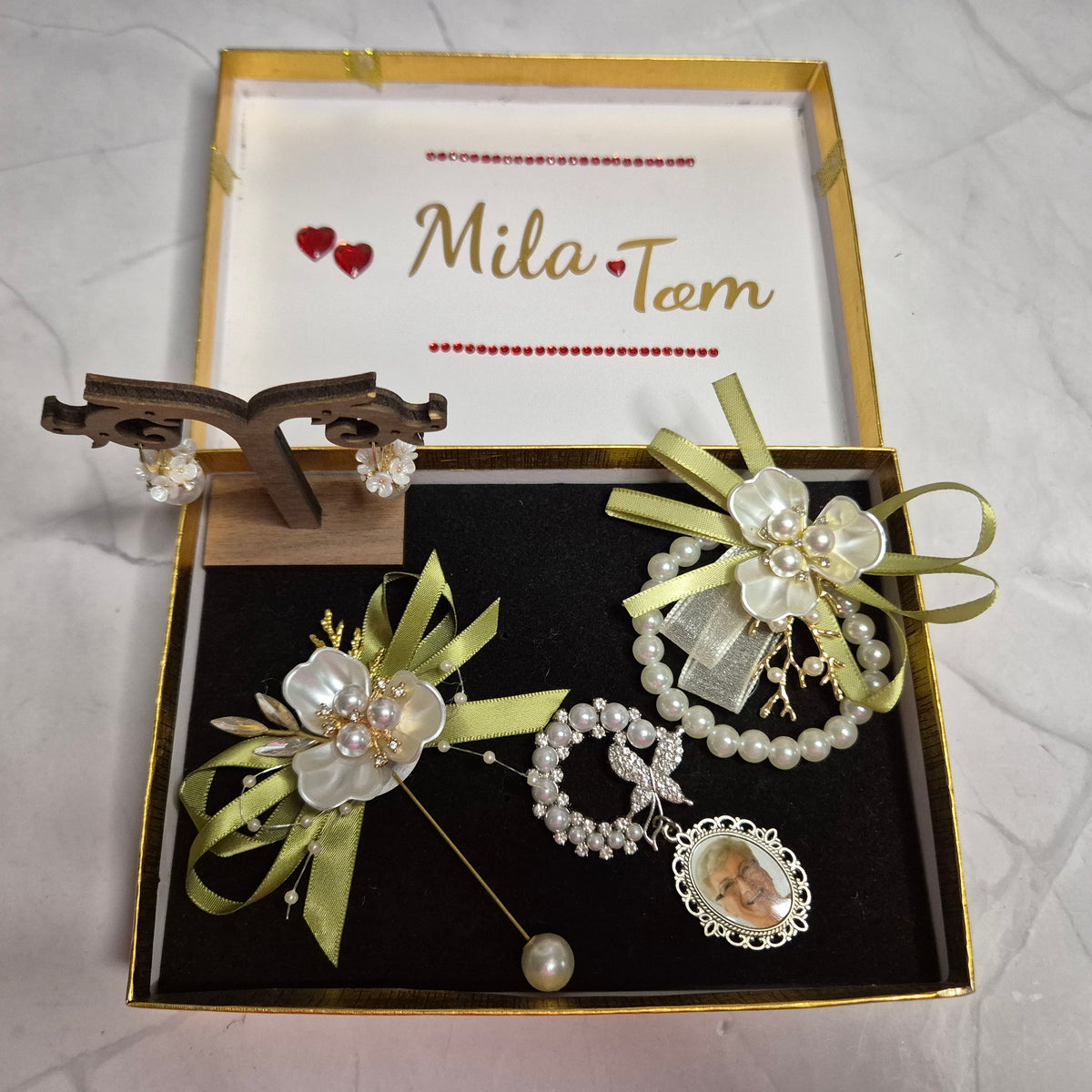 Wedding gift box with a pearl earring, pin charm, and a match corsages