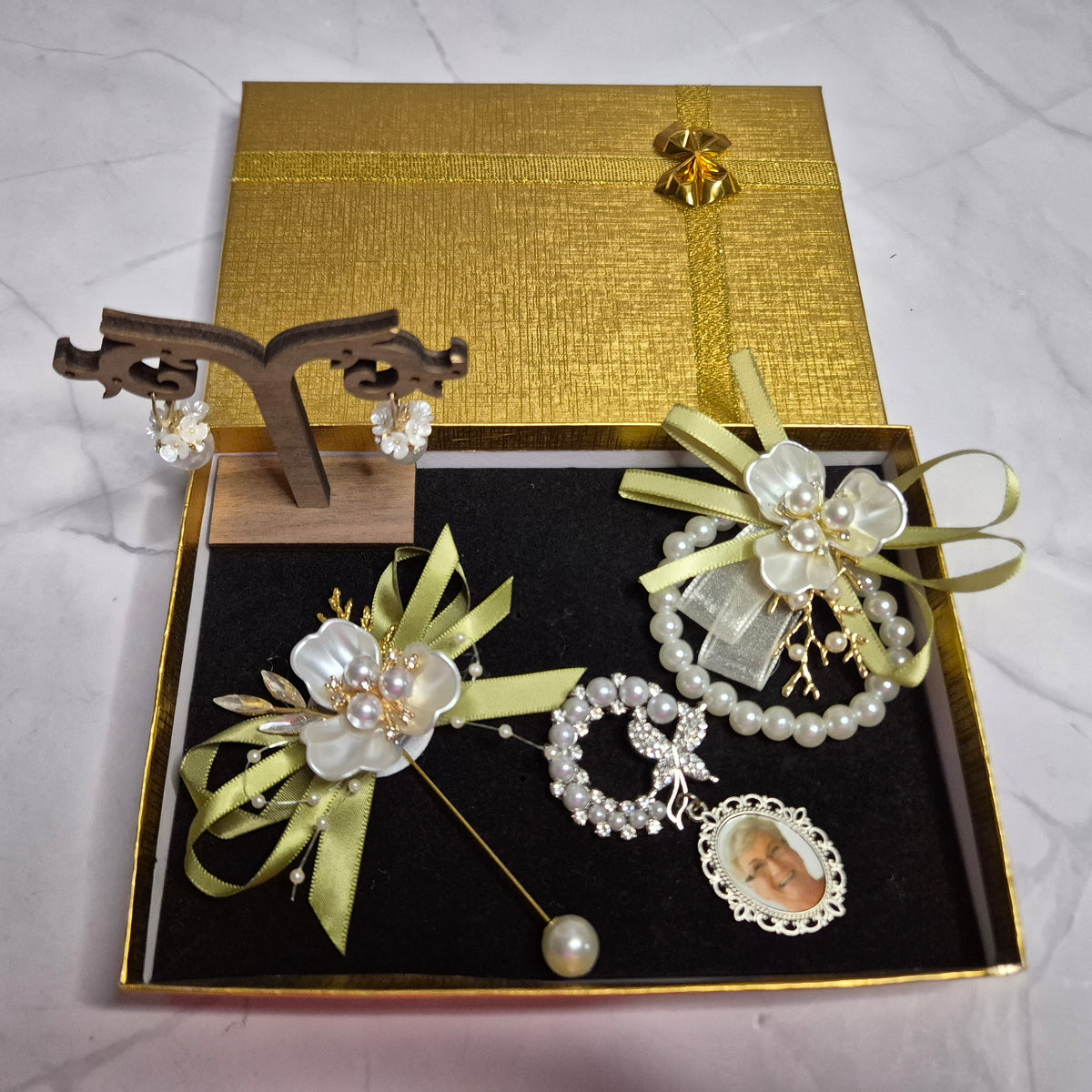 Wedding gift box with a pearl earring, pin charm, and a match corsages
