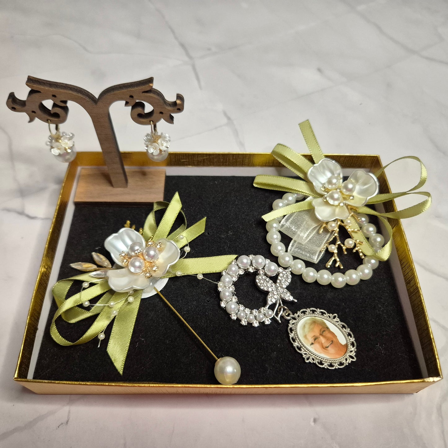 Wedding gift box with a pearl earring, pin charm, and a match corsages