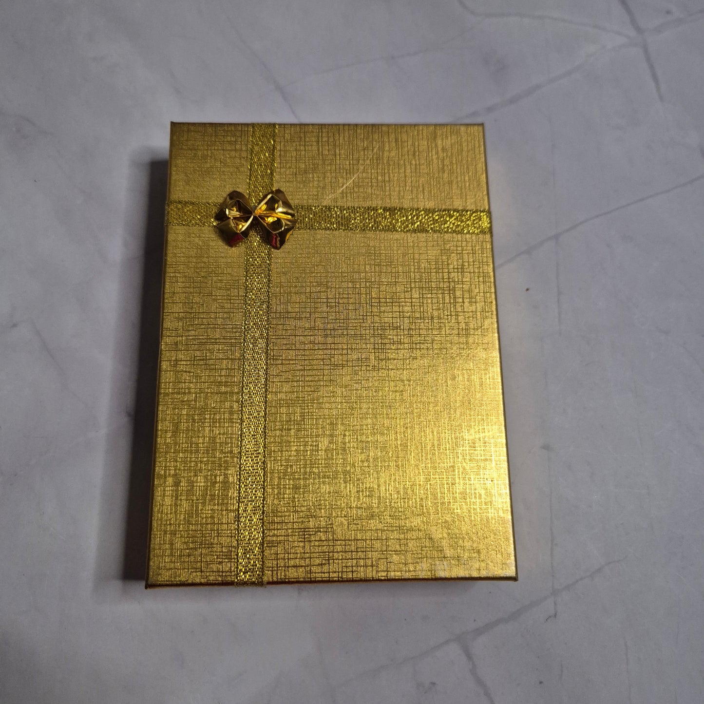 Wedding gift box with a pearl earring, pin charm, and a match corsages